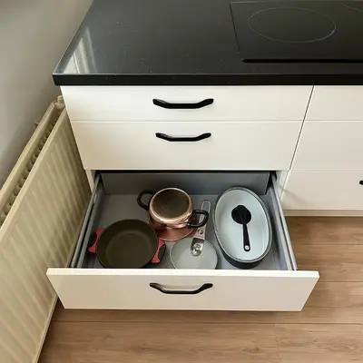 a drawer in a kitchen with pots and pans at Reza Almere in Almere
