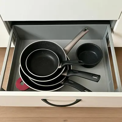 two pots and pans are inside of a drawer at Reza Almere in Almere