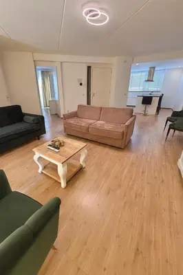 a living room with a couch and a coffee table at Reza Almere in Almere