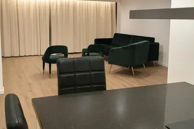 a living room with black chairs and a couch at Reza Almere in Almere