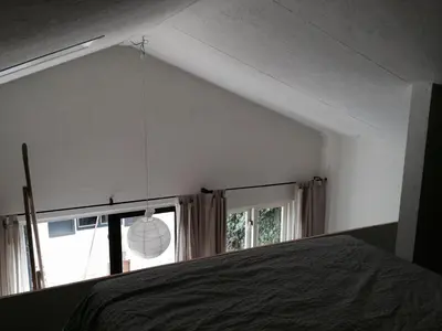 a bedroom with a bed and a window at Almost At The Beach in Wijk aan Zee