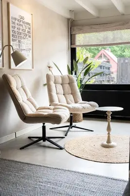 a living room with a chair and a coffee table at -Casa Como- nabij het meer, restaurants & keukenhof in Noordwijkerhout