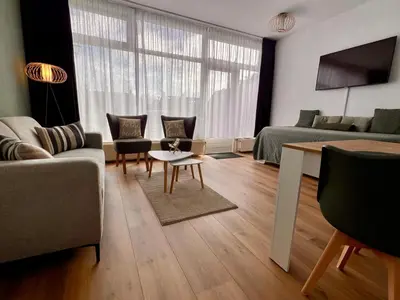 a living room with a couch and a table at Reumann Holiday Apartments De Schelp 12 in Zandvoort