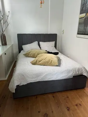 a bed with two pillows on it in a bedroom at Appartement aan het water in Alkmaar