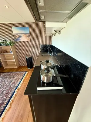 a kitchen with a stove with two pots on it at Holiday Home Vijfhuizen 2pers Lisa in Vijfhuizen
