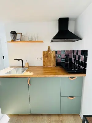 a kitchen with blue cabinets and a sink at BeachHouse Oranje Nassau in Noordwijk aan Zee