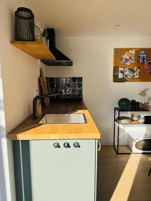 a kitchen with a sink and a counter top at BeachHouse Oranje Nassau in Noordwijk aan Zee