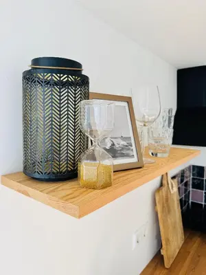 a shelf with a vase and glasses on it at BeachHouse Oranje Nassau in Noordwijk aan Zee