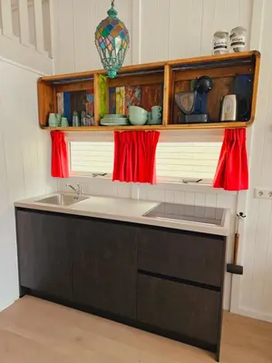 a kitchen with a sink and a counter at Strandvakantiehuisjes Katwijk in Katwijk aan Zee