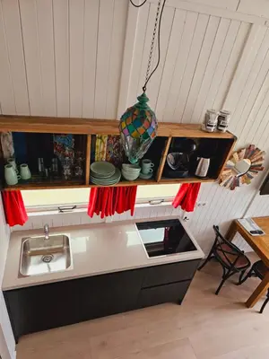 a kitchen with a counter top with a sink at Strandvakantiehuisjes Katwijk in Katwijk aan Zee