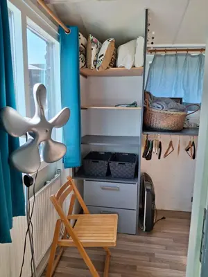 a room with a desk and a chair and a closet at Rekerlanden 211 in Schoorldam