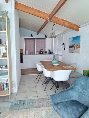 a kitchen and dining room with a table and chairs at Rekerlanden 211 in Schoorldam