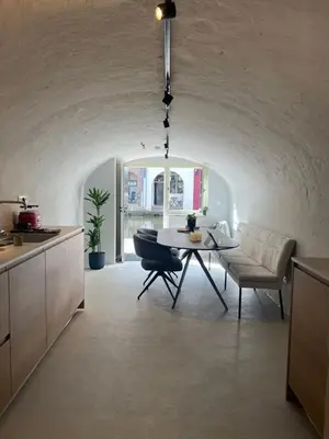 a kitchen and dining room with a table and a couch at Domnacht aan de gracht in Utrecht