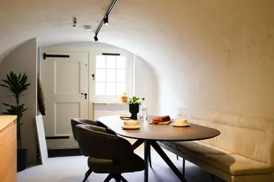 a living room with a table and a couch at Domnacht aan de gracht in Utrecht