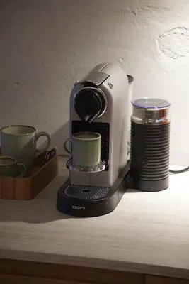 a coffee maker and two cups on a table at Domnacht aan de gracht in Utrecht