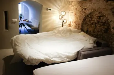 a bedroom with a white bed in a room at Domnacht aan de gracht in Utrecht