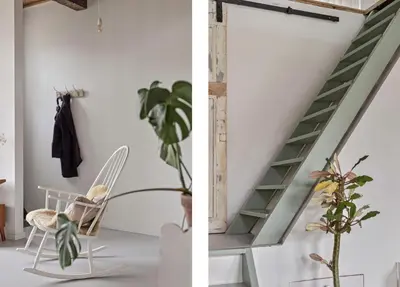 a room with a staircase and a chair and a plant at Boutique Canal house 't Jannetje - historical and cozy in Edam
