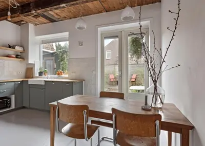 a kitchen with a wooden table and chairs at Boutique Canal house 't Jannetje - historical and cozy in Edam