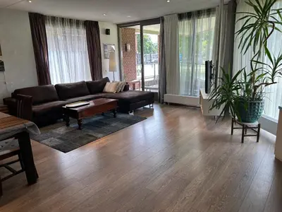a living room with a couch and a table at Lounge Park Apartment in Amsterdam