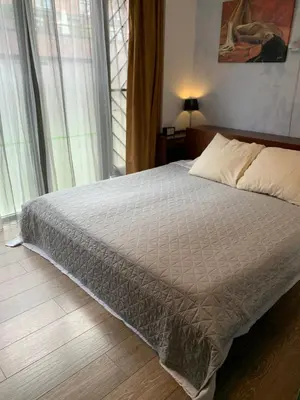 a bedroom with a bed and a large window at Lounge Park Apartment in Amsterdam