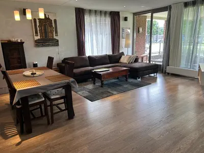 a living room with a couch and a table at Lounge Park Apartment in Amsterdam
