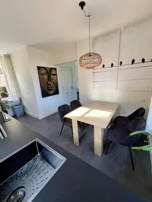 a dining room with a table and some chairs at Rhynhoven Lodge in Hazerswoude-Rijndijk