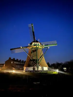 a windmill with lights on it in front of a building at Rhynhoven Lodge in Hazerswoude-Rijndijk