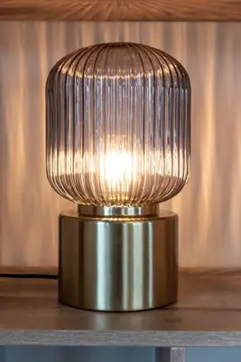 a silver lamp sitting on top of a table at Spacious 120m2 Water Villa With Sauna Near Amsterdam in Aalsmeer
