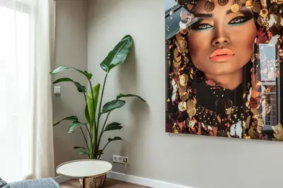 a living room with a painting of a woman at Spacious 120m2 Water Villa With Sauna Near Amsterdam in Aalsmeer