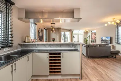 a kitchen with white cabinets and a sink at Spacious 120m2 Water Villa With Sauna Near Amsterdam in Aalsmeer