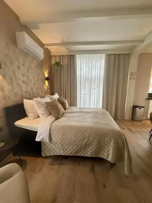 a bedroom with a large bed and a window at Seastreet Suite in Zandvoort