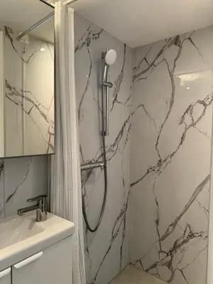 a bathroom with a shower and a sink at Rosalie Apartment in Zandvoort