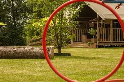 a red hula hoop in front of a house at Zorgcamping De Ruif De Peppelhoeve in Stoutenburg