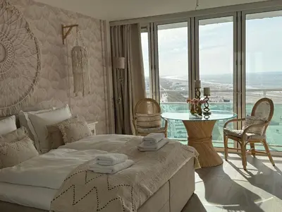 a bedroom with a bed and a table with chairs at Studio Michelle in Zandvoort