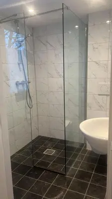 a bathroom with a glass shower and a sink at Bed en Breakfast 1394 in Nederhorst den Berg