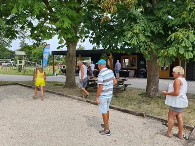 a group of people playing a game in a park at Chalet 7a op Recreatiepark De Wielen in Sint Maarten