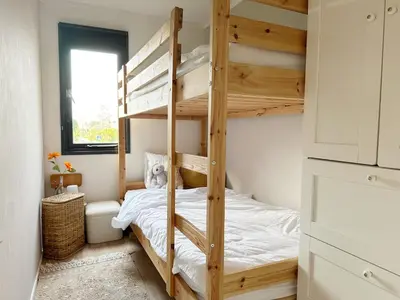 a bedroom with a bunk bed with a ladder at Chalet 552 op Recreatiepark De Wielen in Sint Maarten