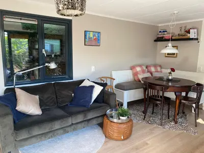 a living room with a couch and a table at Chalet 552 op Recreatiepark De Wielen in Sint Maarten