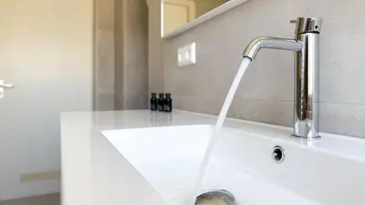 a sink with water coming out of a faucet at Zon aan den Hoef by Droomvilla in Egmond aan den Hoef