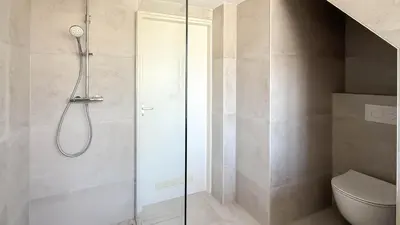 a shower with a glass door in a bathroom at Zon aan den Hoef by Droomvilla in Egmond aan den Hoef