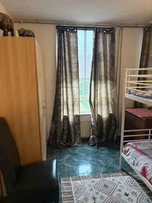 a bedroom with a window with curtains and a bed at B&B Calypso Amsterdam in Amsterdam