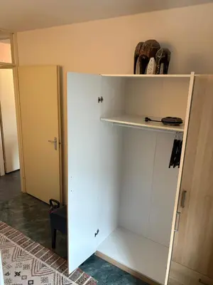 a closet with a white door and a shelf at B&B Calypso Amsterdam in Amsterdam