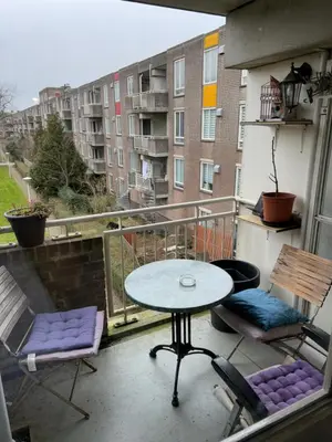 a patio with a table and chairs on a balcony at B&B Calypso Amsterdam in Amsterdam