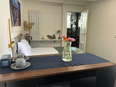 a table with a vase of flowers on top of it at Leoicom in Zandvoort