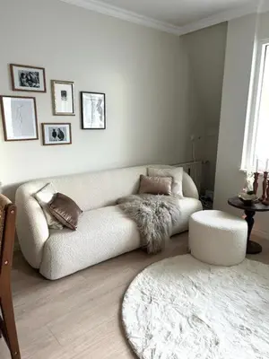 a living room with a white couch and a rug at Have a nice stay! - Duinloft 150 m from the beach in Noordwijk