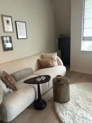 a living room with a couch and a table at Have a nice stay! - Duinloft 150 m from the beach in Noordwijk