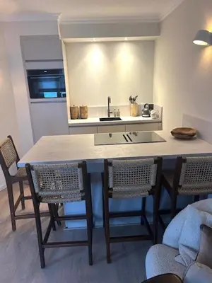 a kitchen with a table with chairs and a sink at Have a nice stay! - Duinloft 150 m from the beach in Noordwijk