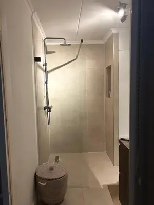 a bathroom with a shower with a glass door at Have a nice stay! - Duinloft 150 m from the beach in Noordwijk