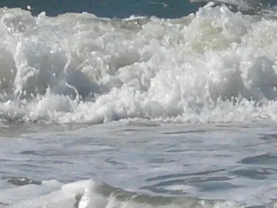 a foamy wave in the ocean on the beach at Quarles 80 - free parking in Noordwijk aan Zee