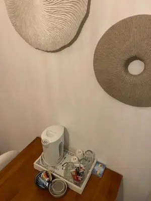 a table with a coffee maker and a mirror on a wall at Quarles 80 - free parking in Noordwijk aan Zee